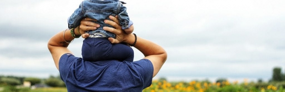 young girl on shoulders of father