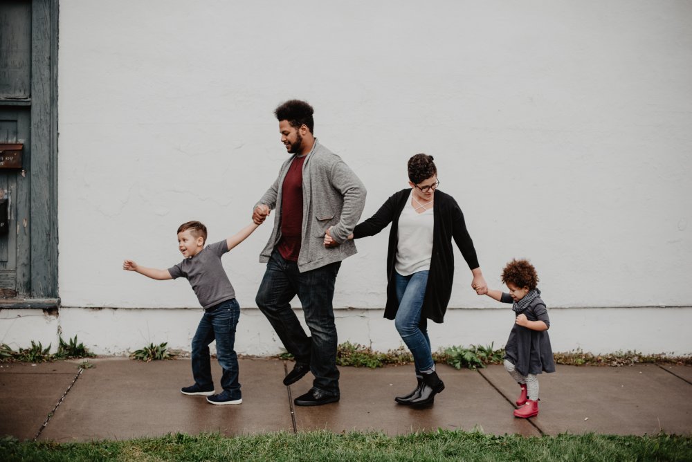 happy family walking on wet sidewalk