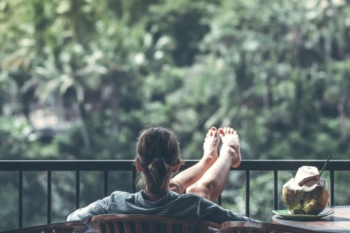 woman sitting on deck with feet up on rail