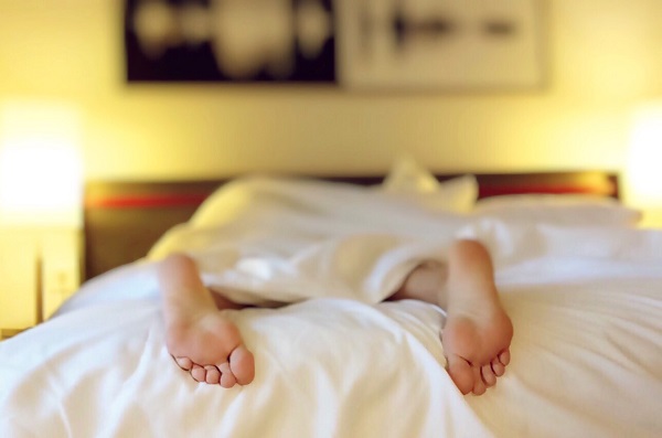 woman in bed with only feet exposed