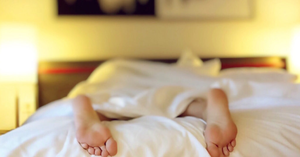 feet out of covers in hotel room bed