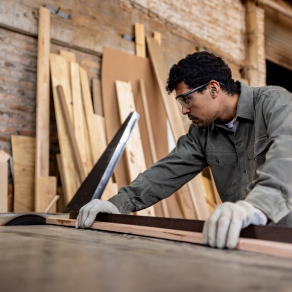 construction worker with earplugs in enclosed building