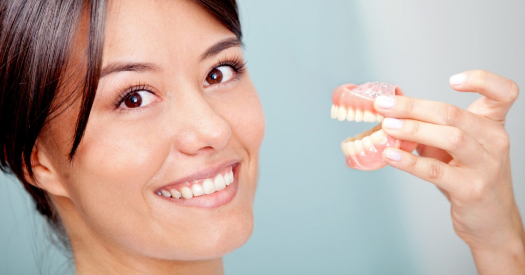 Woman holding mouth mold