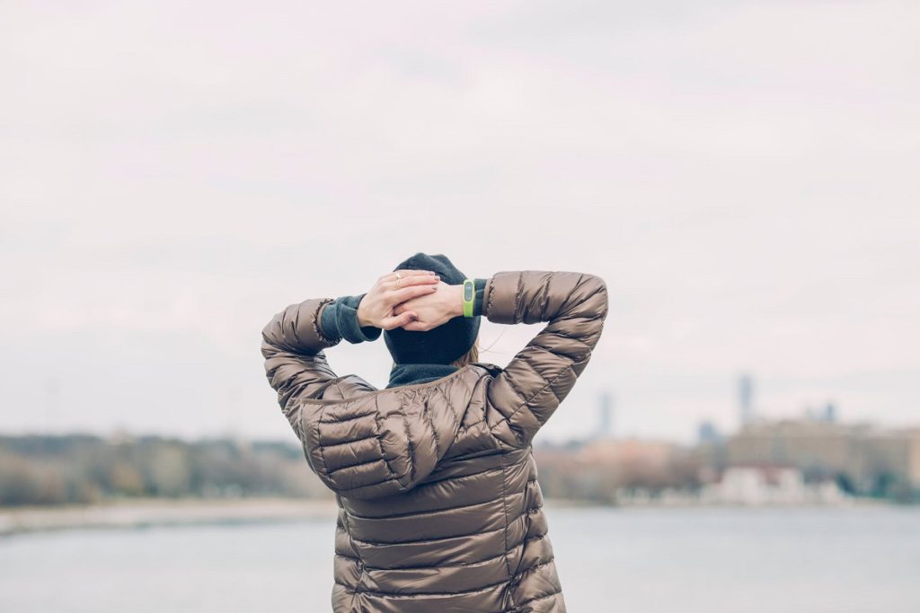 woman in heavy down coat looking at skyline