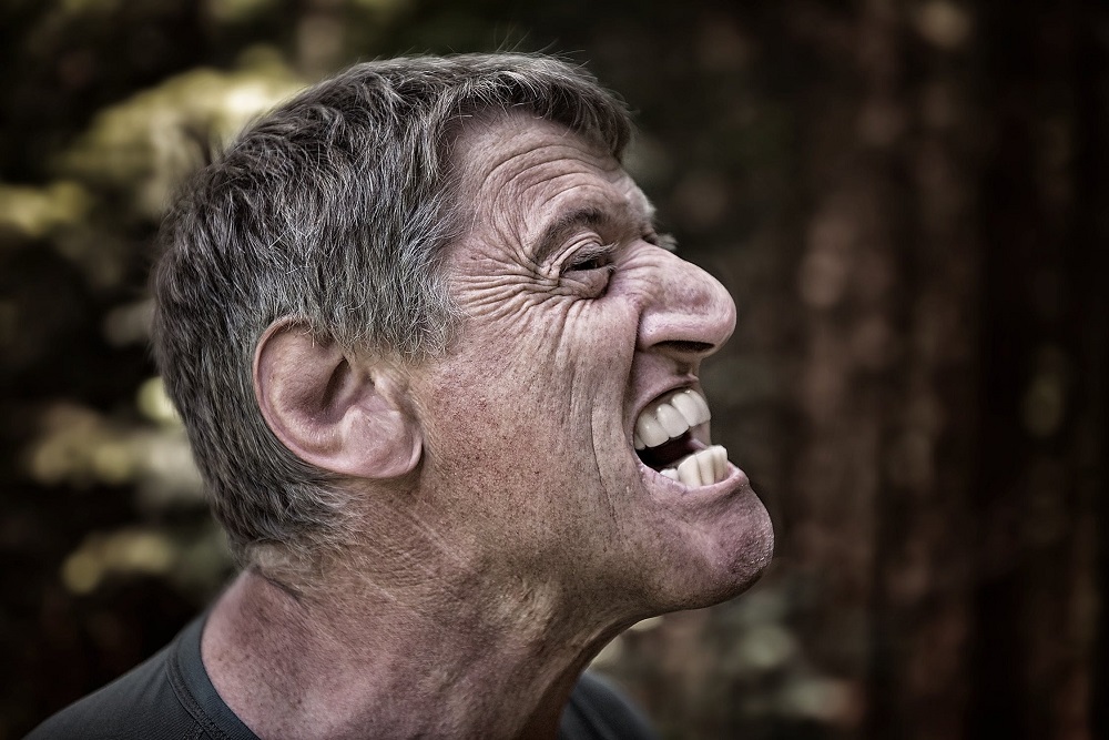 man angry and clinching jaw