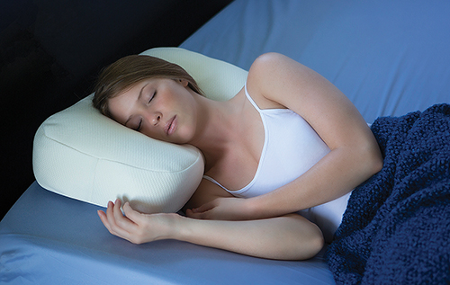 Woman resting well side sleeping on pillow