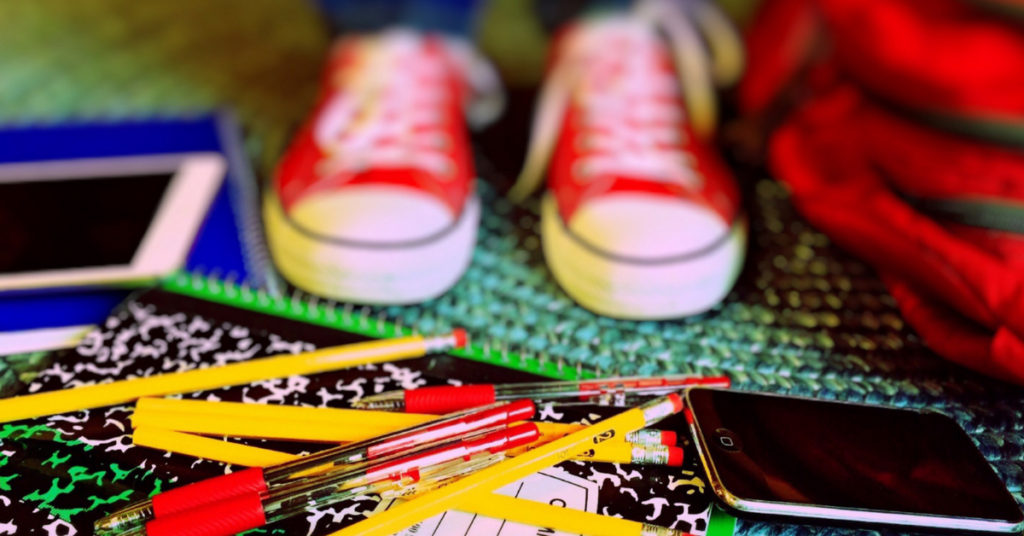 Cellphone, red pens and notebooks