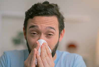 Man blowing nose