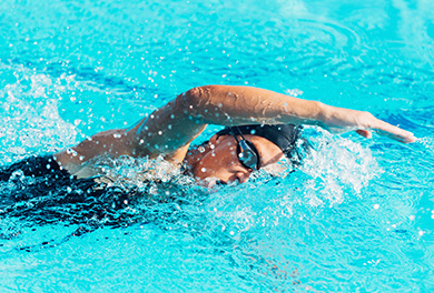 Swimmer freestyling across water